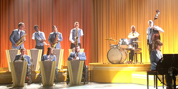 Alvin Law playing drums with his feet as part of an ensemble