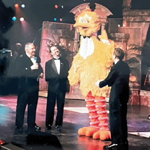 Alvin Law on stage with Big Bird and two other men