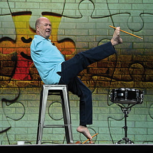 Alvin Law on stage playing the drums with his foot